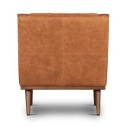 A leather recliner chair with tufted buttons.