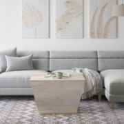 Square-shaped coffee table with a modern design and elegant copper detailing