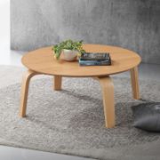 Round coffee table with curved, angled legs reflecting a modern design