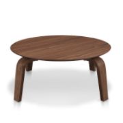 Round coffee table with curved, angled legs reflecting a modern design