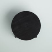 Round coffee table with curved, angled legs reflecting a modern design